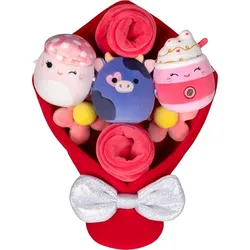 A plush bouquet featuring three cute, round stuffed animals, including a pink mushroom, a purple cow, and a pink drink, wrapped in a red and pink arrangement with a sparkly silver bow.