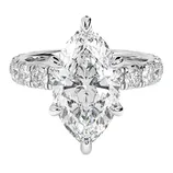 A marquise-cut diamond ring with additional round diamonds set into the band, all in a polished silver or white gold setting.