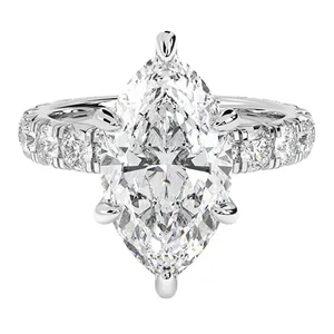 A marquise-cut diamond ring with additional round diamonds set into the band, all in a polished silver or white gold setting.