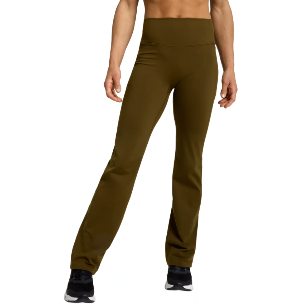 High-waisted olive green flare leggings paired with black and white athletic shoes.