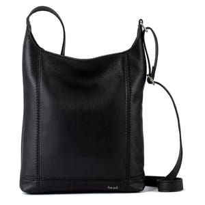 A black leather crossbody bag with a textured finish, featuring an adjustable strap and embossed with \“the sak\“ branding.
