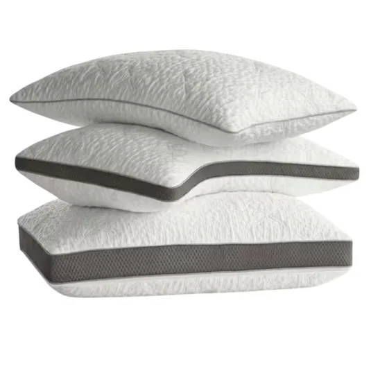 A stack of three white pillows with dark gray trim, each featuring a textured pattern on the fabric.