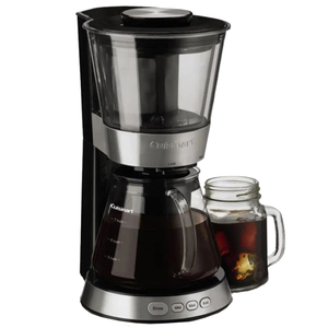 Cuisinart cold brew coffee maker with a glass carafe at the bottom and a transparent top for brewing, alongside a mason jar filled with iced coffee.