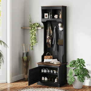 Hall tree with storage bench, coat hooks, and shoe storage shelves, accompanied by hanging jackets, hats, and a plant.