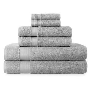 A stack of six grey bath towels of varying sizes.