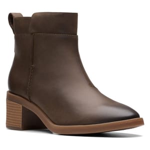 Brown ankle boot with a low stacked heel and smooth, rounded toe, featuring a pull tab at the back and minimal stitching details.