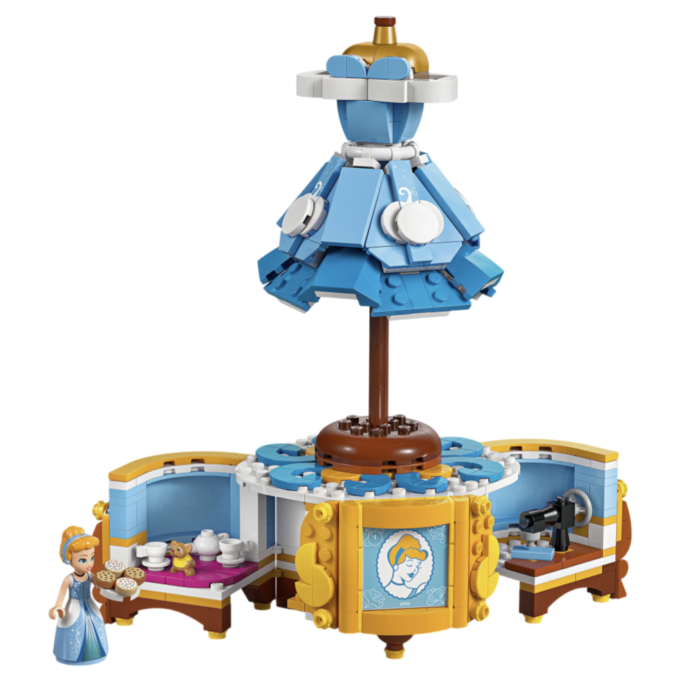 LEGO set featuring a miniature figure with accessories, including a blue gown, tea set, and sewing area, designed around a central rotating structure with decorative elements.