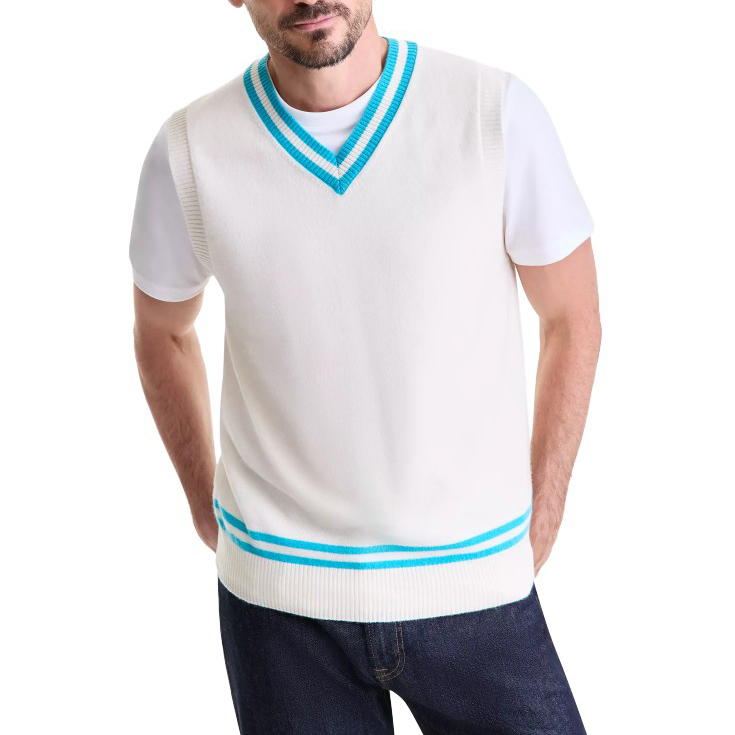 A man wears a white sleeveless sweater vest with light blue trim over a white t-shirt, paired with dark jeans.