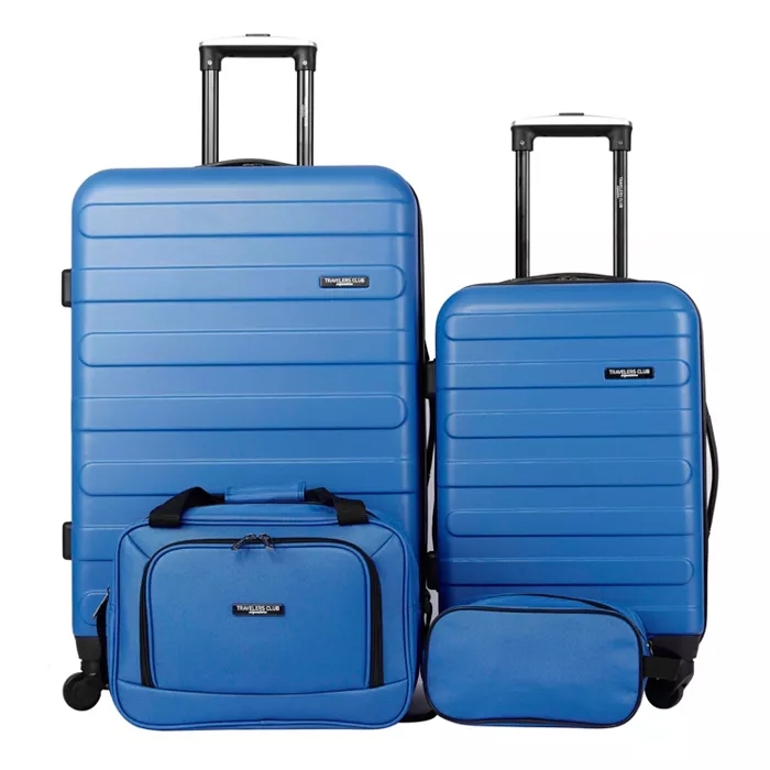 Blue 4-piece hardside luggage set includes two suitcases with wheels and telescoping handles, a carry-on bag, and a toiletry bag. All pieces feature a uniform design with horizontal grooves and \“Travelers Club\“ branding.