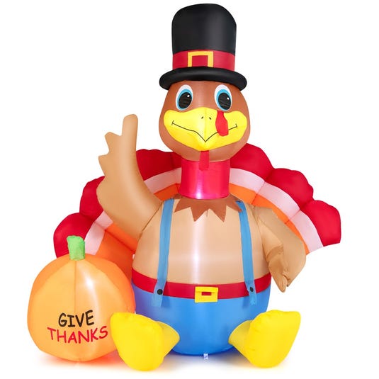 Inflatable turkey decoration dressed in blue overalls and a pilgrim hat, holding a pumpkin with the words \“Give Thanks.\“