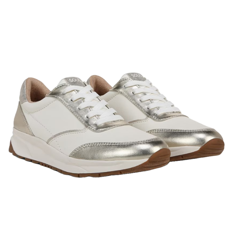 Naturalizer Jackson Lace Up Sneaker features a white base with metallic silver accents, white laces, and brown rubber soles, offering a stylish and comfortable design.