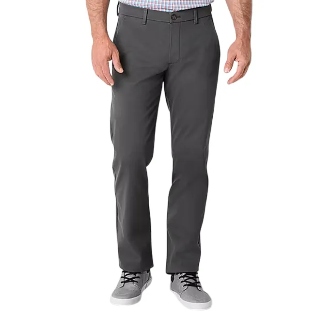 A person wearing dark gray straight-leg pants paired with light gray sneakers and a checkered shirt.