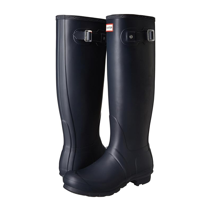 A pair of tall, navy blue rubber boots with adjustable straps and the Hunter logo on the front.