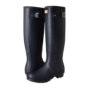 A pair of tall, navy blue rubber boots with adjustable straps and the Hunter logo on the front.