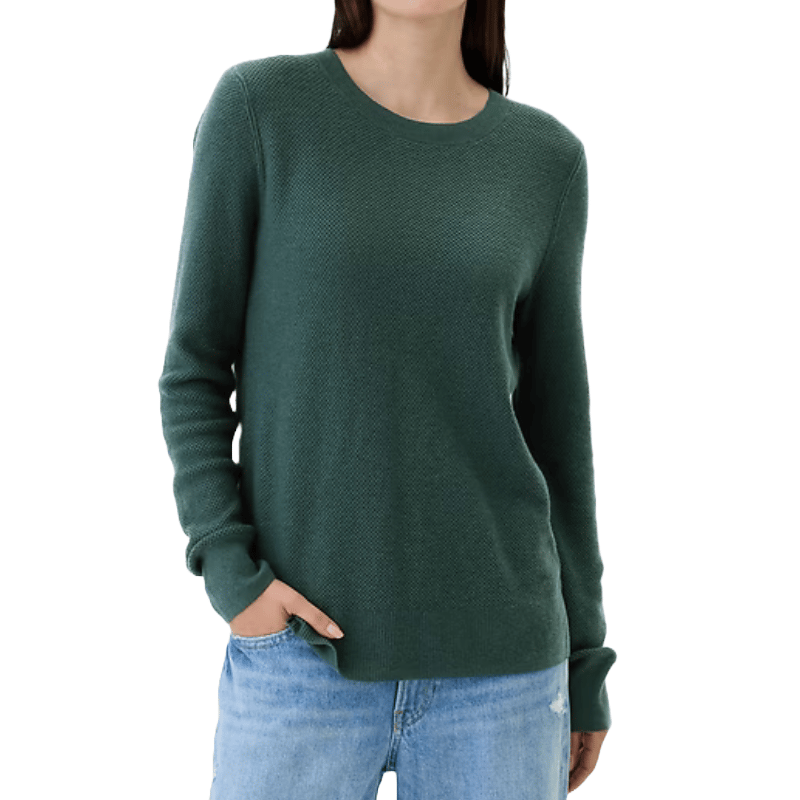 Green textured crewneck sweater with long sleeves and a relaxed fit, paired with light blue jeans.