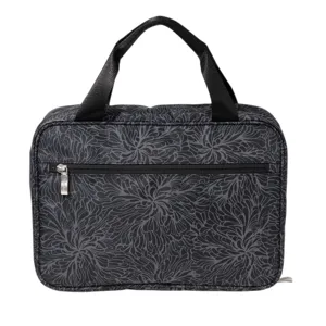 A black bag with a floral pattern, featuring a front zipper pocket and two handles for carrying.
