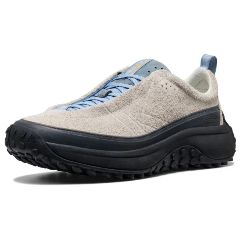 A sneaker with a textured beige upper, blue laces, and black rugged sole, suitable for outdoor activities.