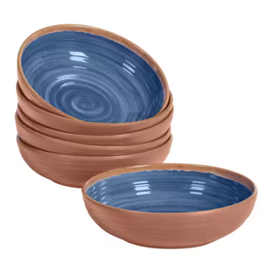 A stack of terracotta bowls with blue glazed interior.