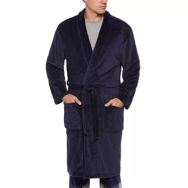 A man is wearing a navy blue bathrobe with a shawl collar and waist tie.