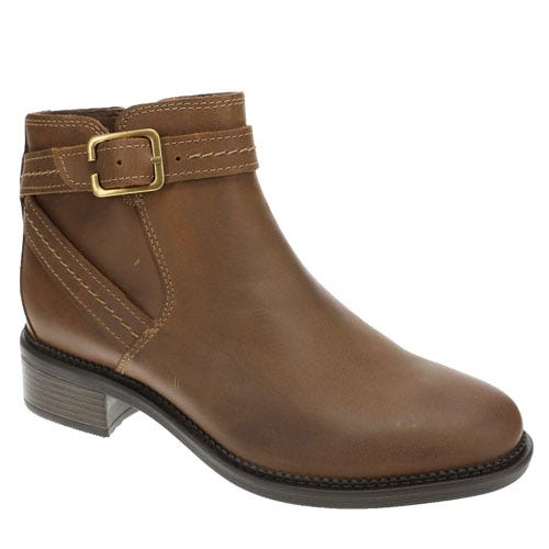 Brown ankle boot with a side buckle and low heel. Made of leather with stitching details.