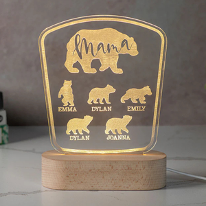 A glowing acrylic sign features a bear design personalized with the word \“Mama\“ and names Emma, Dylan, Emily, Joanna. The sign sits on a wooden base and is illuminated from below.