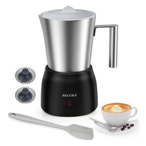 Electric milk frother with a stainless steel jug and black base; includes two whisk attachments and a spatula. A cappuccino cup with latte art is shown alongside.