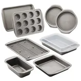 A set of nonstick bakeware including muffin tin, loaf pan, circular and rectangular baking pans, cooling rack, and covered cake pan.