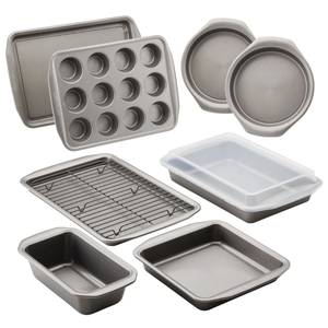 A set of nonstick bakeware including muffin tin, loaf pan, circular and rectangular baking pans, cooling rack, and covered cake pan.
