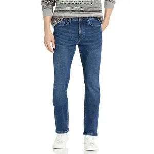 A person wearing straight-leg blue jeans, a patterned sweater, and white sneakers.