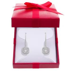 A pair of square-shaped diamond earrings with hooks, presented in a red gift box with a bow.