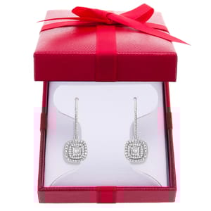 A pair of square-shaped diamond earrings with hooks, presented in a red gift box with a bow.