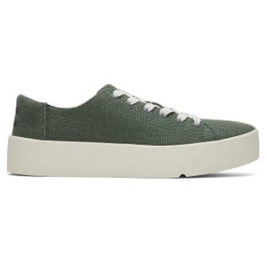 TOMS Lace-Up Sneakers feature a green canvas upper with white laces and a thick white platform sole, providing a casual and stylish look.