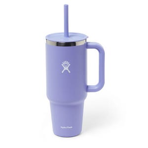 A purple Hydro Flask tumbler with a handle, lid, and straw.
