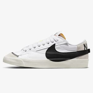 White low-top sneaker with black Nike Swoosh logo and yellow heel accent.