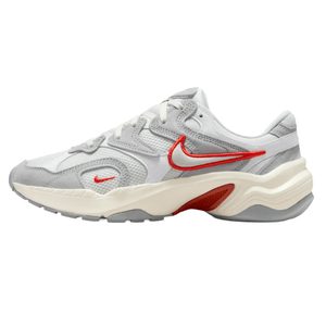 A white and gray sneaker featuring red branding and accents, with a chunky, textured sole design.