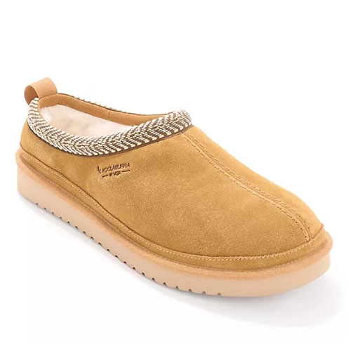 Tan suede slip-on slippers with a chunky sole and a contrasting woven trim around the opening.