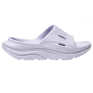 Hoka Ora Recovery Slides are white, open-toe slip-ons with a thick, cushioned sole for comfort and support. They feature ventilation slots and the Hoka logo on the side.