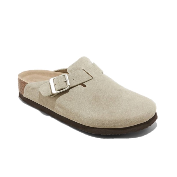 A beige suede slip-on clog with a single adjustable strap and buckle, featuring a cork footbed and dark sole.