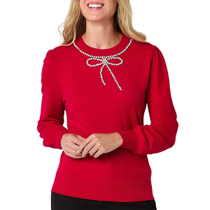 Red sweater with long sleeves, featuring a pearl-embellished bow design at the neckline.