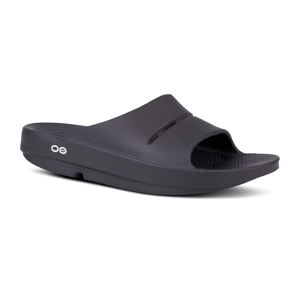 Black slide sandal with a single wide strap and textured footbed, featuring a small circular logo on the side.