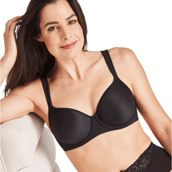 A woman is wearing a black underwire bra with wide straps and lace trim on matching black underwear.