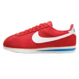 Red Nike Cortez sneaker with a white swoosh, detailed with blue accents on the sole and heel, featuring a classic silhouette and rugged outsole.