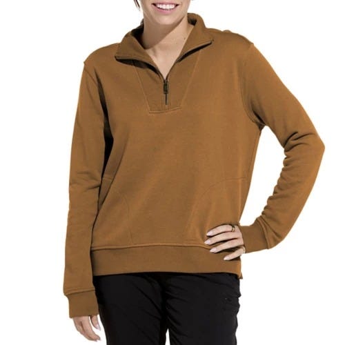 A person wears a brown quarter-zip pullover with a pocket, paired with black pants.