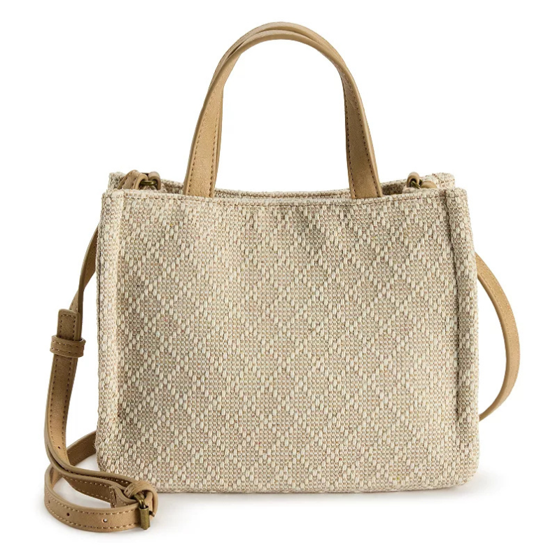 Tan woven tote bag with a textured pattern, featuring dual handles and an adjustable shoulder strap.