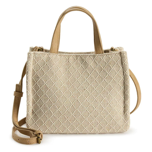 Tan woven tote bag with a textured pattern, featuring dual handles and an adjustable shoulder strap.