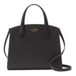 A black Kate Spade New York handbag with dual top handles and a shoulder strap, featuring a structured design and the brand's logo in gold lettering on the front.
