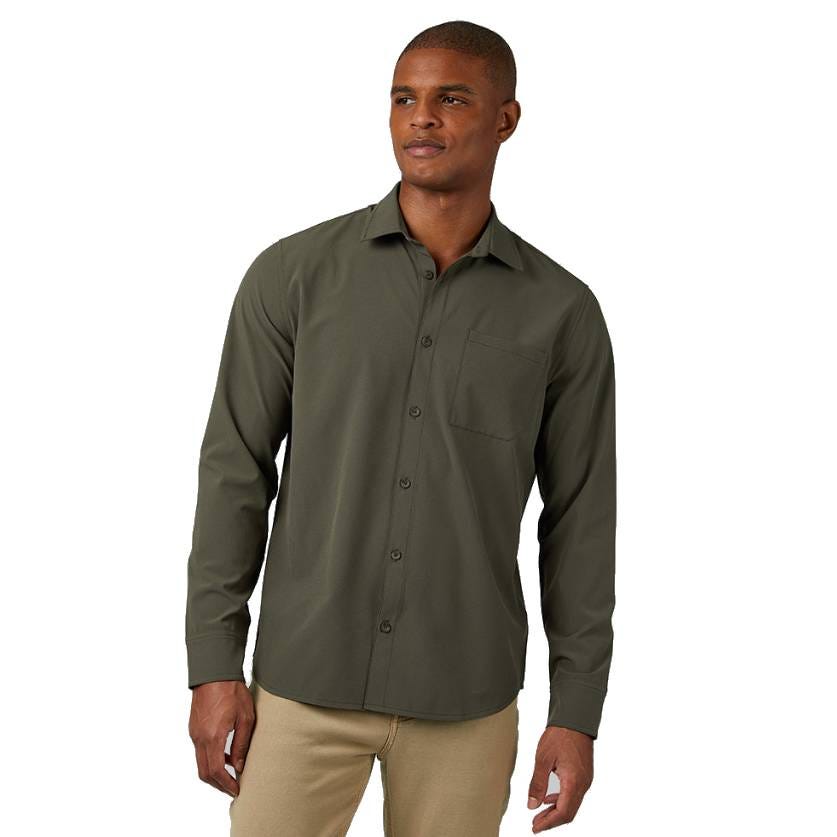 A man is wearing a long-sleeve, olive green button-up shirt with a chest pocket, paired with beige pants.