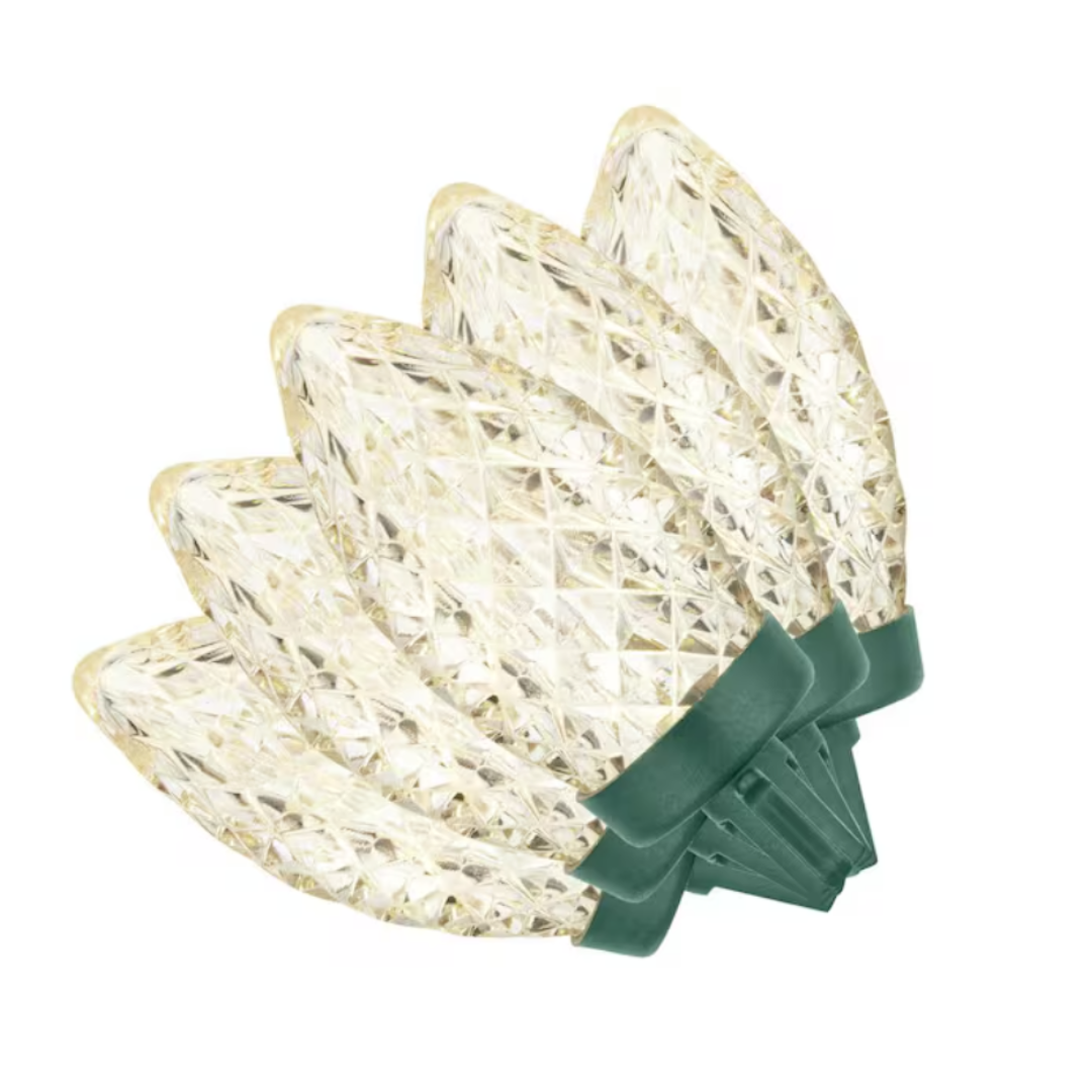 A set of clear, faceted C9 LED string lights with green bases, resembling large, textured teardrop bulbs.