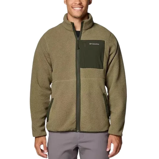 A man wears a green Columbia fleece jacket with a zippered chest pocket and side pockets.