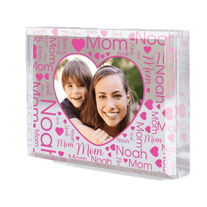 Clear keepsake block featuring a heart-shaped photo of a mother and child, surrounded by the words \“Mom\“ and \“Noah\“ in pink with heart designs.
